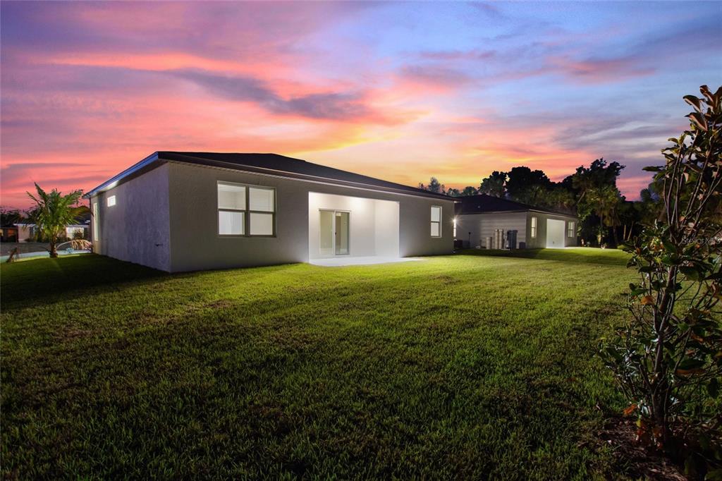 24399 Southwest Kingsway Circle Punta Gorda, FL 33983 - Photo 33 of 38 a front view of house with yard and trees in the background