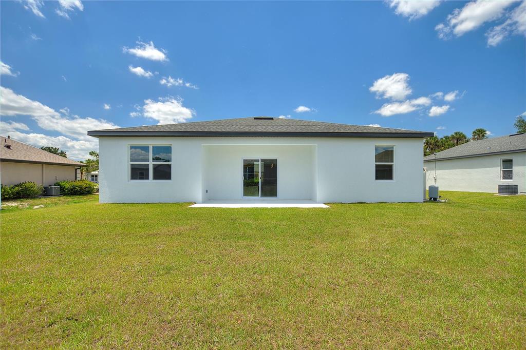 24399 Southwest Kingsway Circle Punta Gorda, FL 33983 - Photo 36 of 38 a view of a house with backyard and a garden