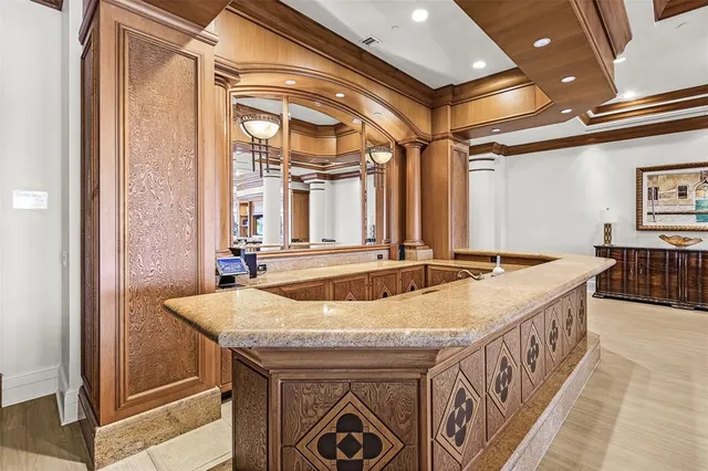 a bathroom with a granite countertop sink and a large mirror