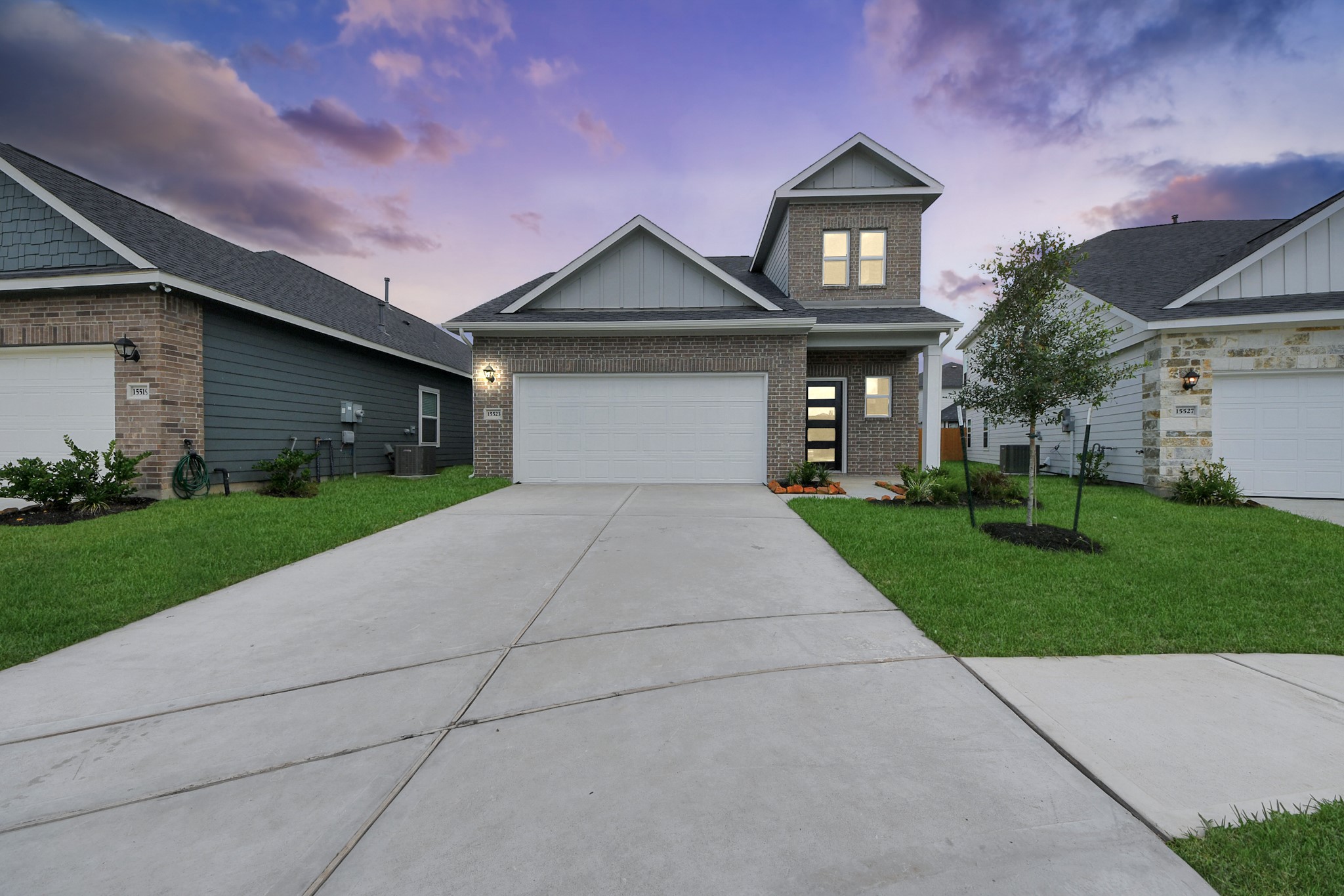 15523 Fathom Line Way Houston, TX 77053 - Photo 2 of 39 This home has a well-maintained lawn and charming landscaping, set against a picturesque sunset sky.