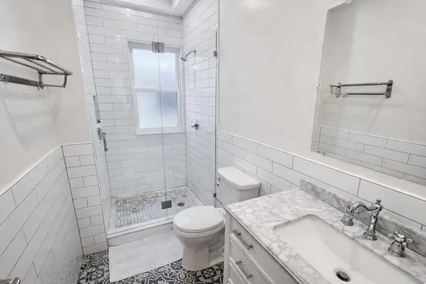 a bathroom with a sink toilet and shower