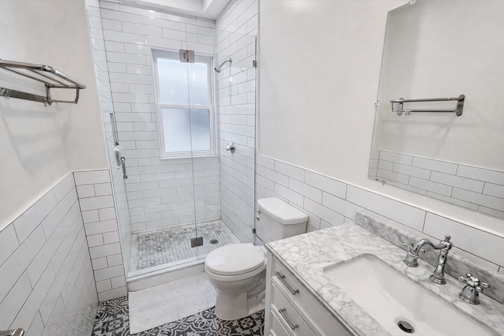 35 Foster Street, Unit 1 Boston, MA 02135 - Photo 12 of 21 a bathroom with a sink toilet and shower