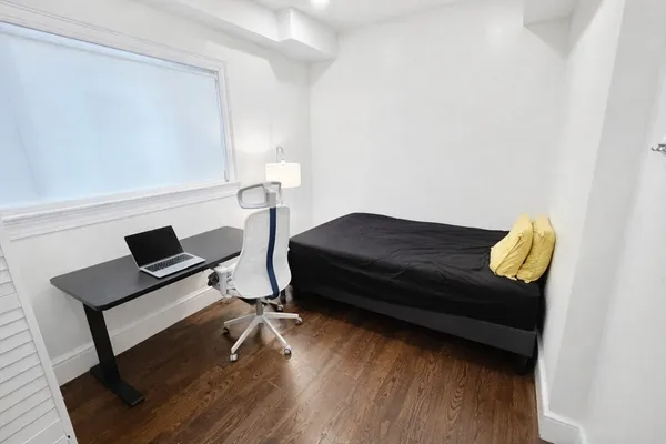 a bedroom with a bed and a night stand