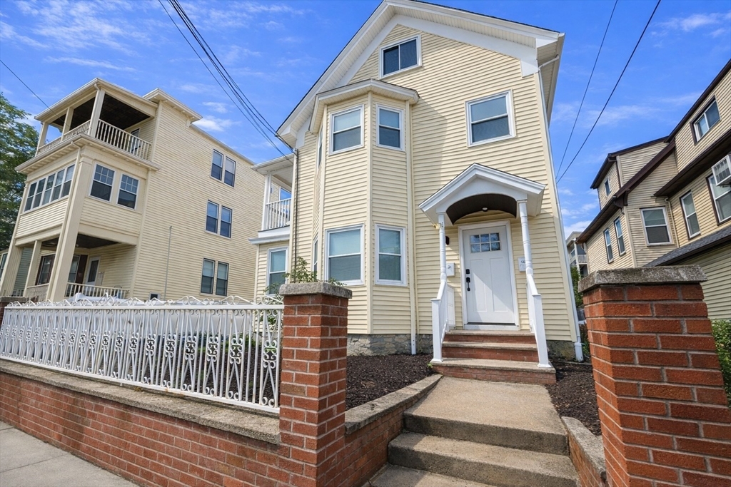 35 Foster Street, Unit 1 Boston, MA 02135 - Photo 2 of 21 a front view of a house with a porch