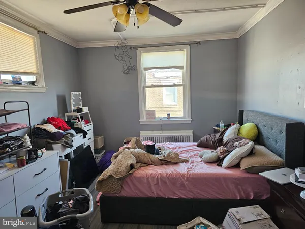 a bedroom with two beds and a chandelier