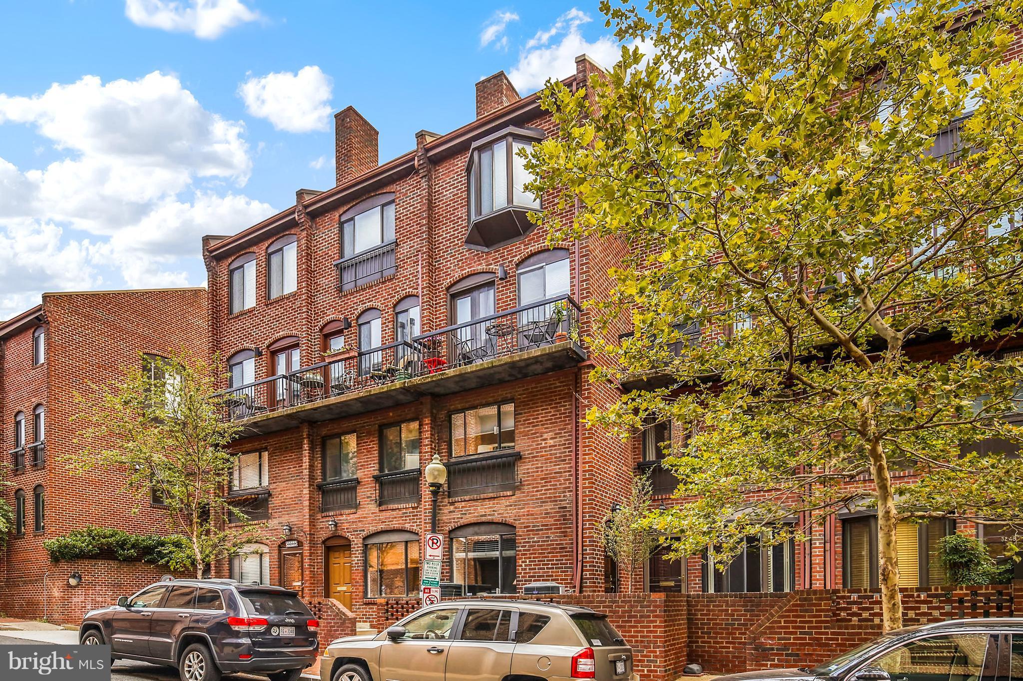 a couple of cars parked in front of brick building