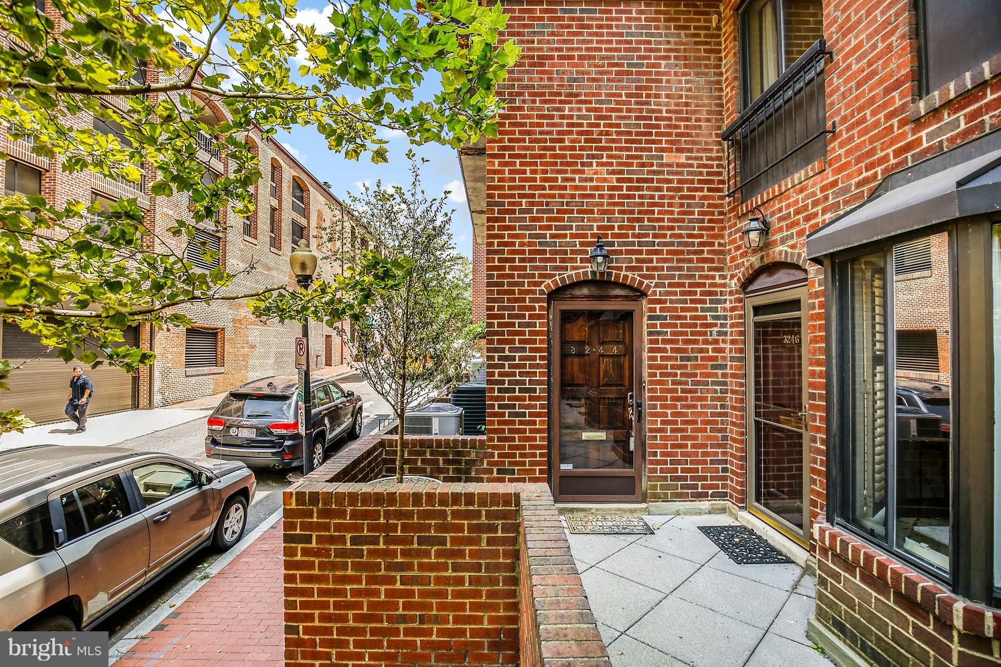 3244 Grace Street Northwest, Unit 3244 Washington, DC 20007 - Photo 2 of 22 a front view of a house with a garden