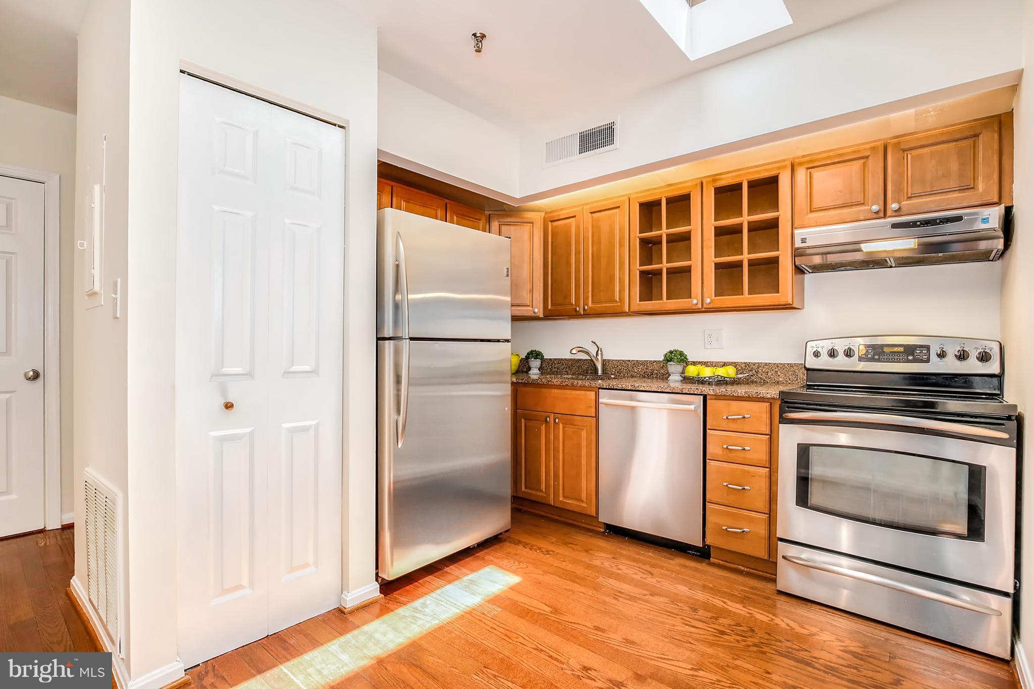 3244 Grace Street Northwest, Unit 3244 Washington, DC 20007 - Photo 11 of 22 a kitchen with stainless steel appliances granite countertop a refrigerator and a stove