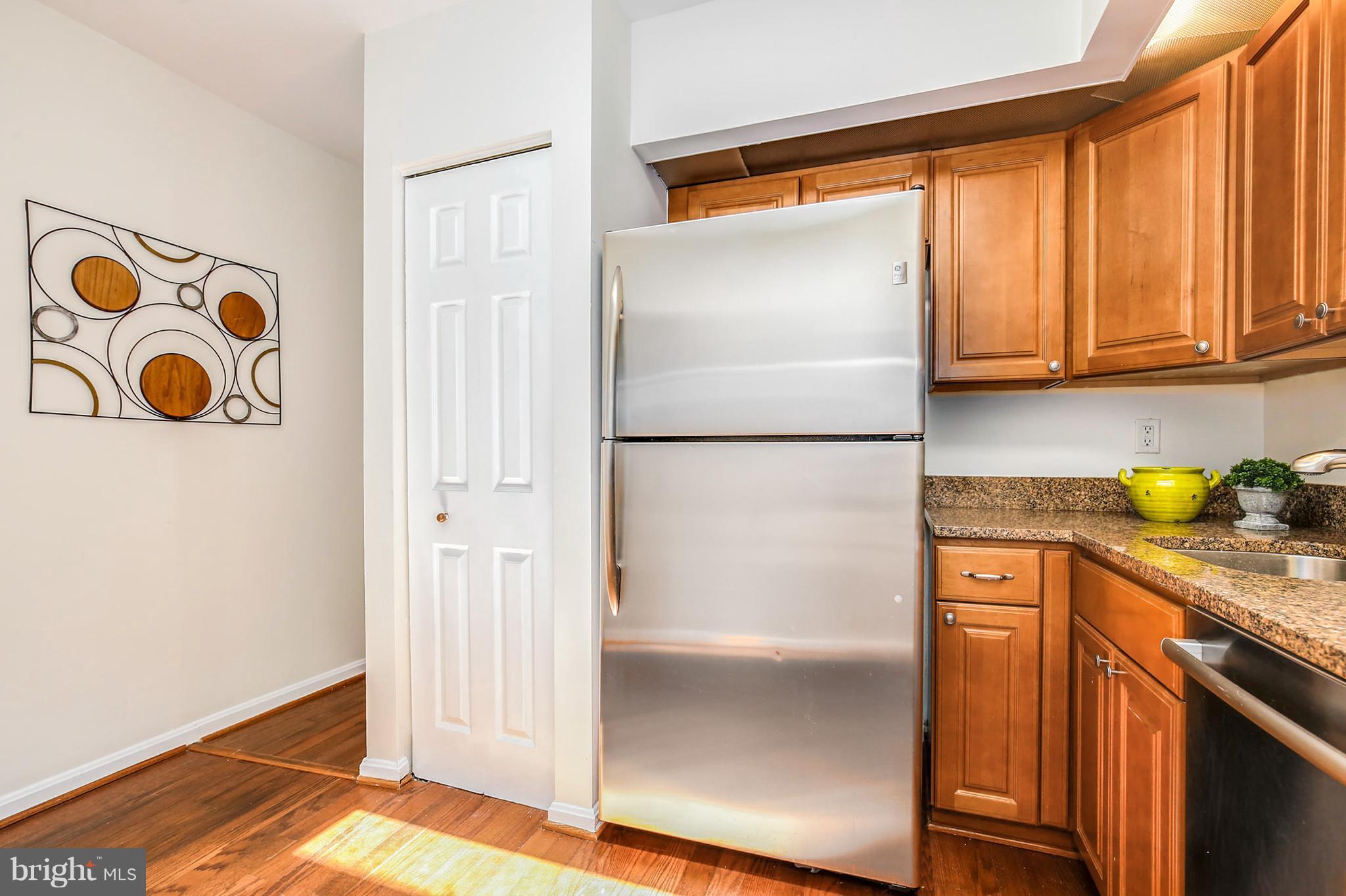 3244 Grace Street Northwest, Unit 3244 Washington, DC 20007 - Photo 12 of 22 a kitchen with stainless steel appliances granite countertop a refrigerator and a stove