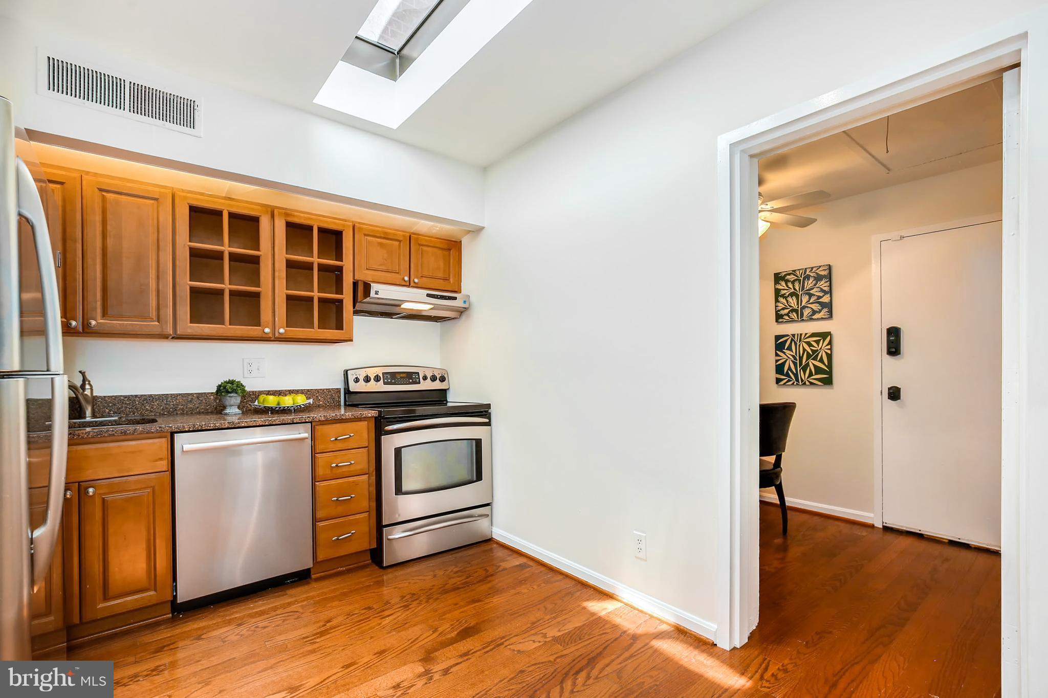 3244 Grace Street Northwest, Unit 3244 Washington, DC 20007 - Photo 13 of 22 a kitchen with stainless steel appliances granite countertop a stove and a refrigerator