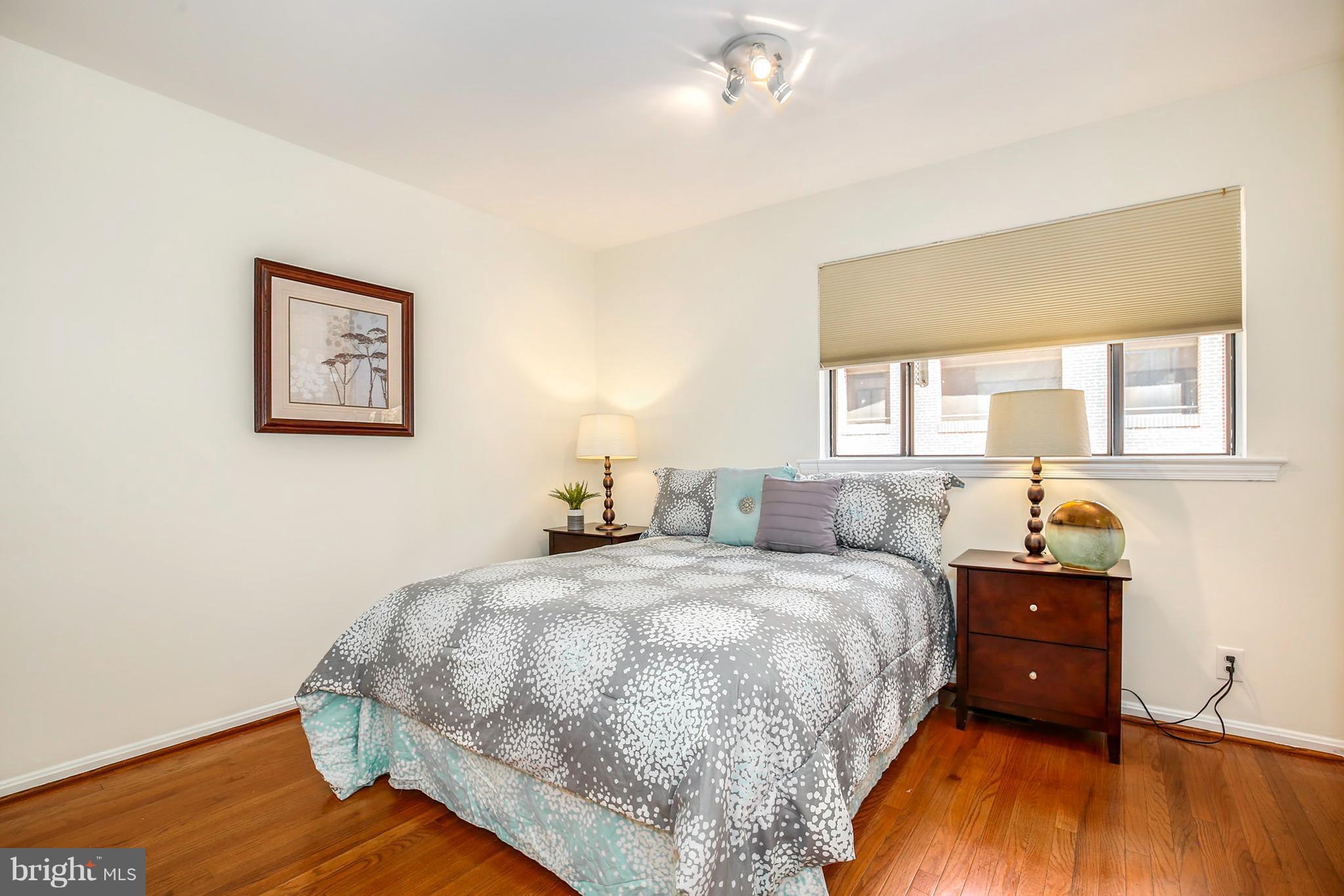 3244 Grace Street Northwest, Unit 3244 Washington, DC 20007 - Photo 15 of 22 a bedroom with a bed and wooden floor