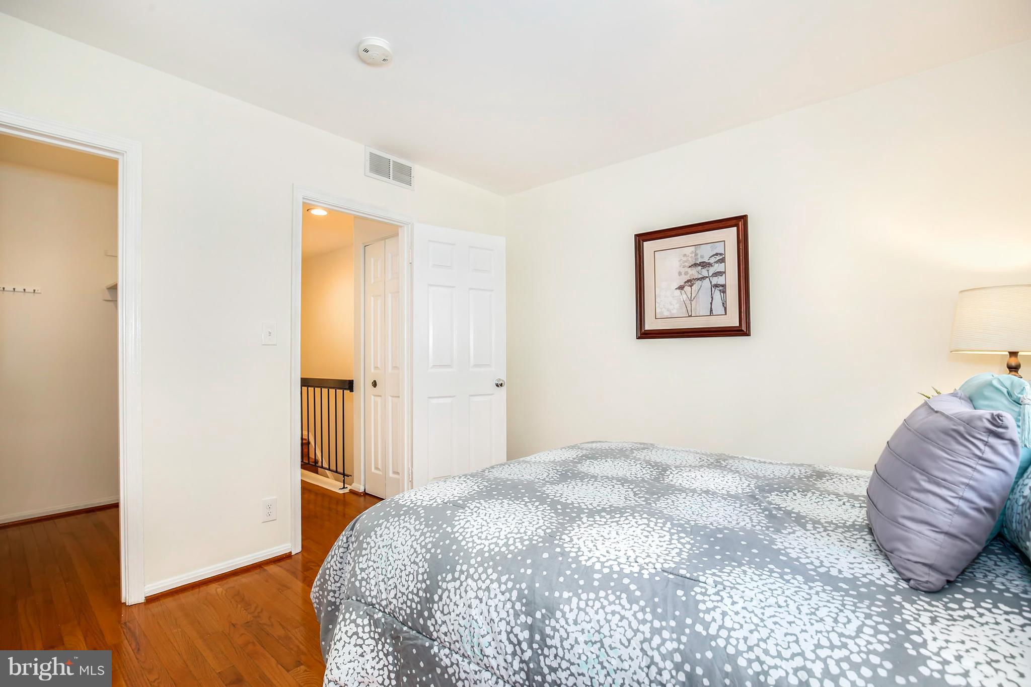 3244 Grace Street Northwest, Unit 3244 Washington, DC 20007 - Photo 16 of 22 a bedroom with a bed and a couch