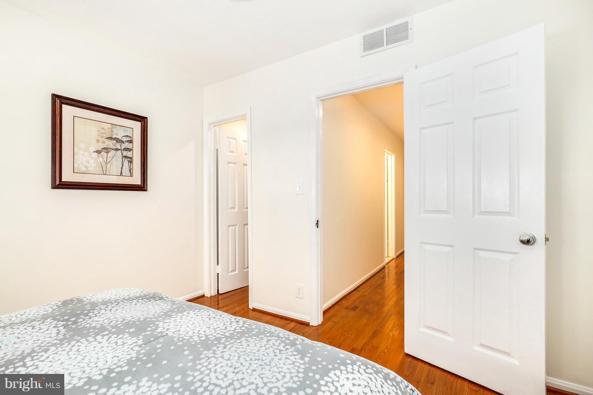 3244 Grace Street Northwest, Unit 3244 Washington, DC 20007 - Photo 17 of 22 a view of a bedroom with wooden floor and hallway