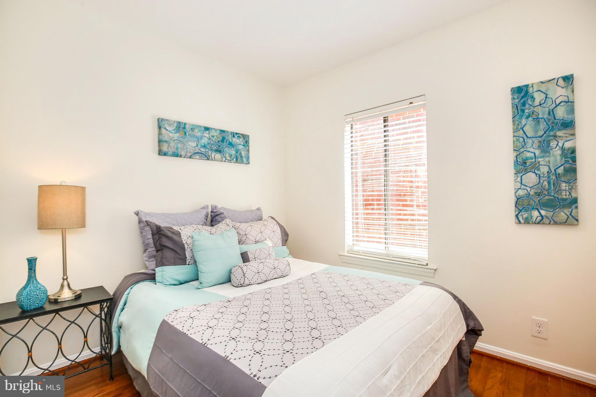 3244 Grace Street Northwest, Unit 3244 Washington, DC 20007 - Photo 19 of 22 a bedroom with a bed and a night stand