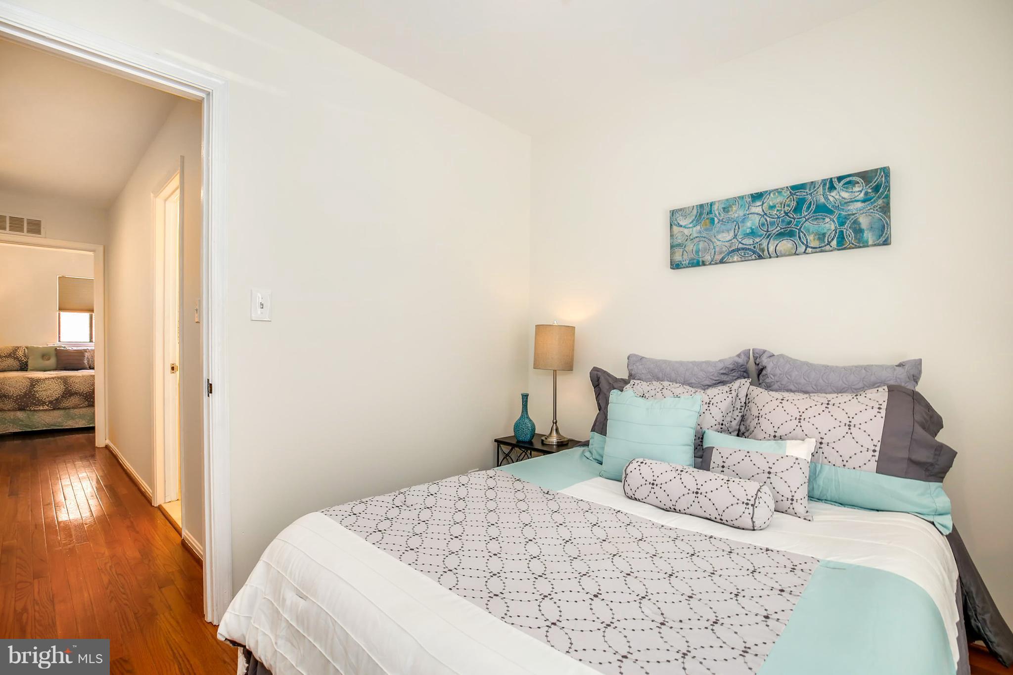 3244 Grace Street Northwest, Unit 3244 Washington, DC 20007 - Photo 20 of 22 a bedroom with a bed and wooden floor