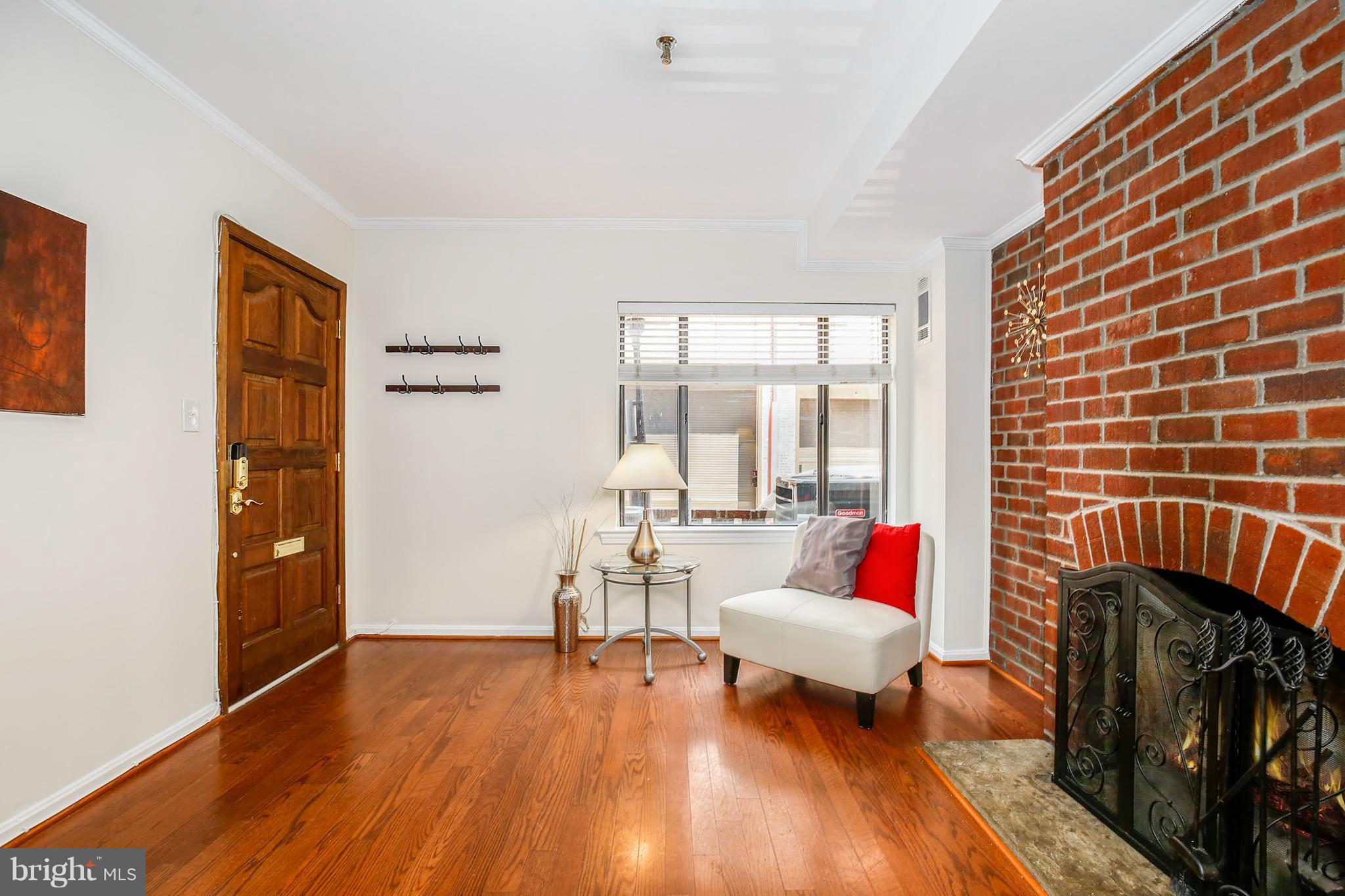 3244 Grace Street Northwest, Unit 3244 Washington, DC 20007 - Photo 4 of 22 a living room with furniture and wooden floor