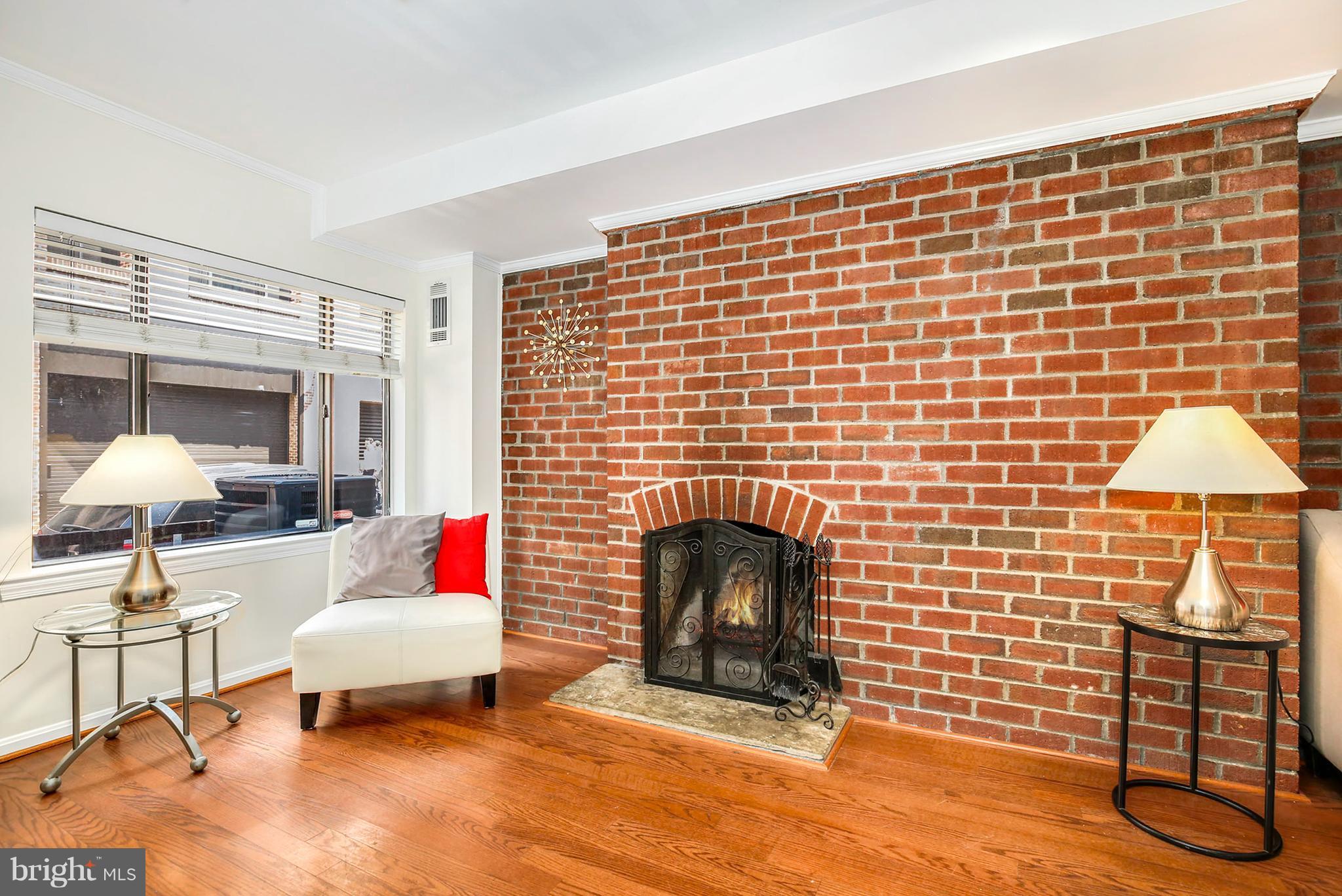 3244 Grace Street Northwest, Unit 3244 Washington, DC 20007 - Photo 5 of 22 a living room with furniture and a fireplace