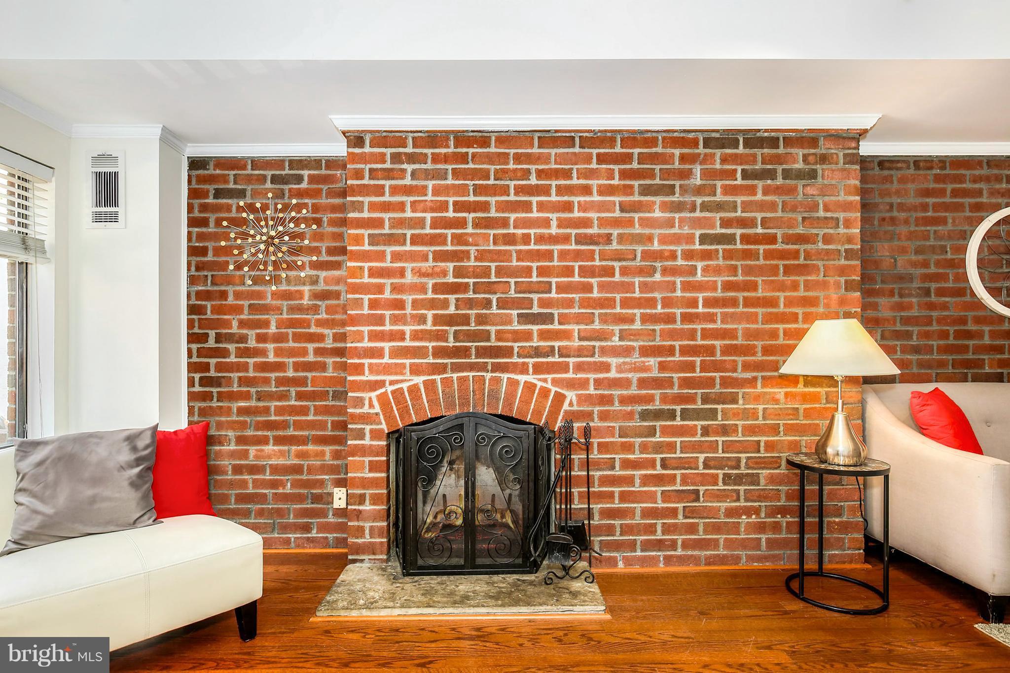 3244 Grace Street Northwest, Unit 3244 Washington, DC 20007 - Photo 6 of 22 a living room with furniture and a fireplace