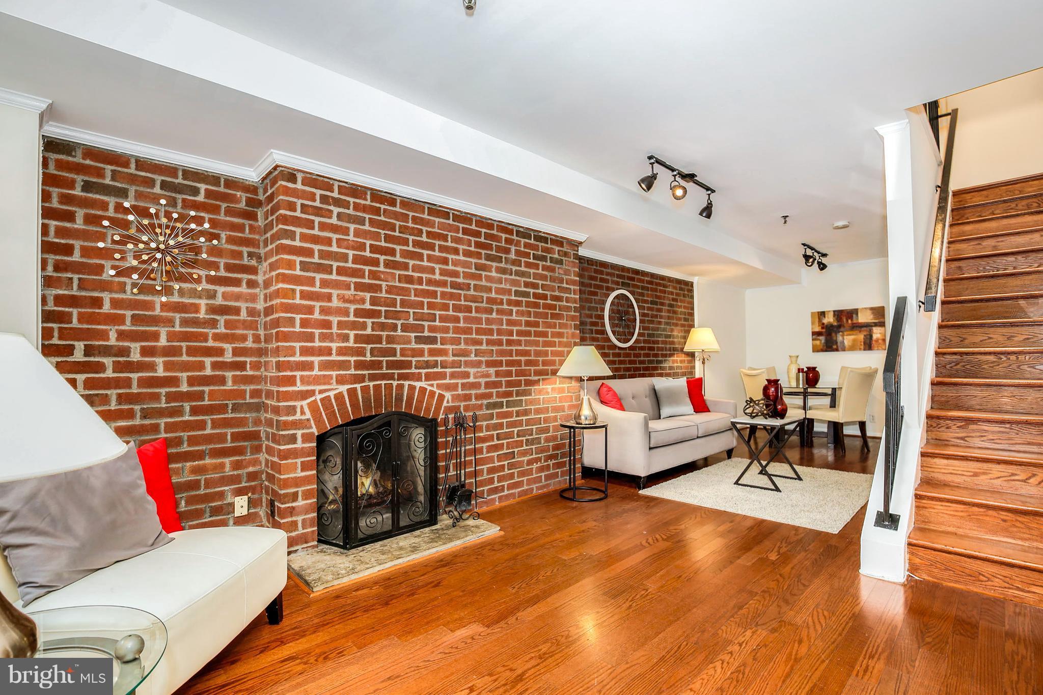3244 Grace Street Northwest, Unit 3244 Washington, DC 20007 - Photo 7 of 22 a living room with furniture and a fireplace