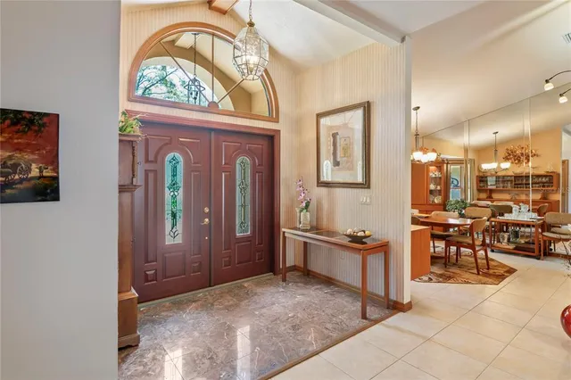 an empty room with fan and windows