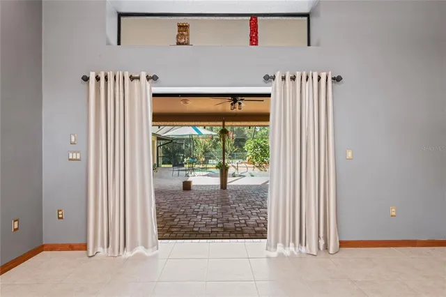 a kitchen with stainless steel appliances granite countertop a table chairs and refrigerator