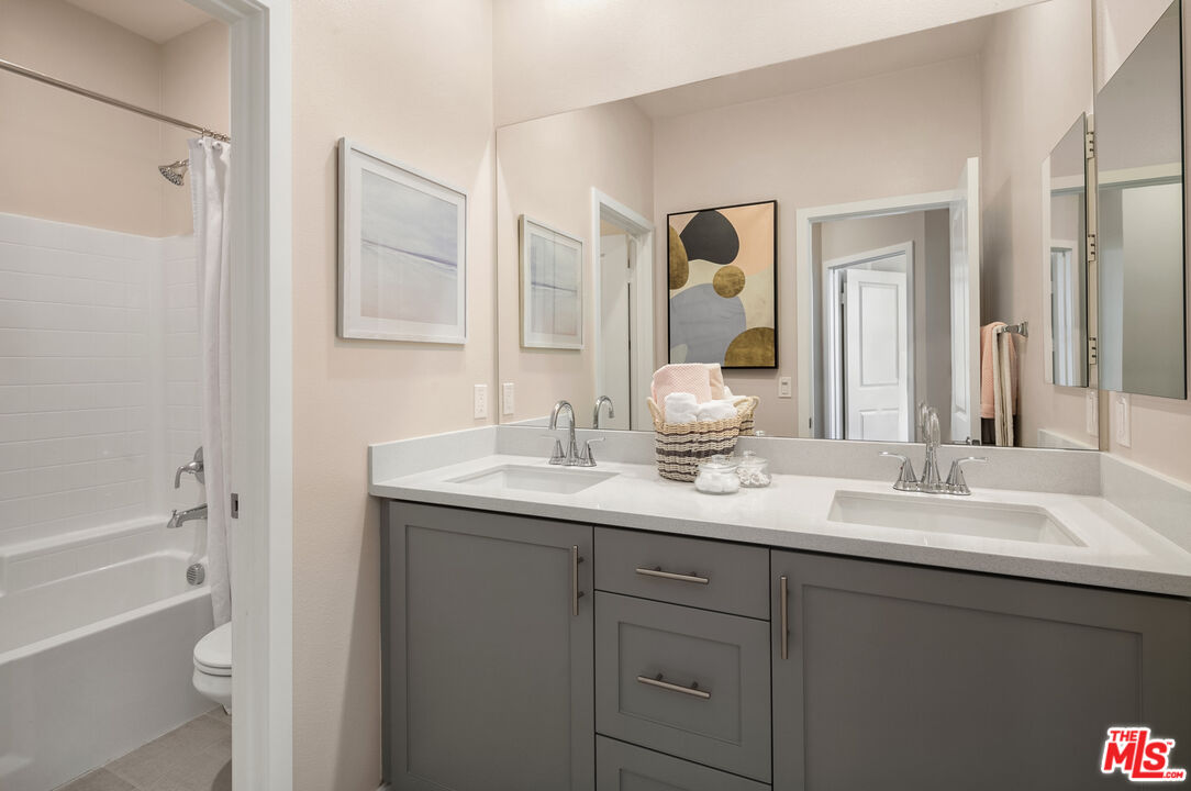 1385 Chervil Way Upland, CA 91786 - Photo 13 of 17 a bathroom with a granite countertop sink mirror and a bathtub