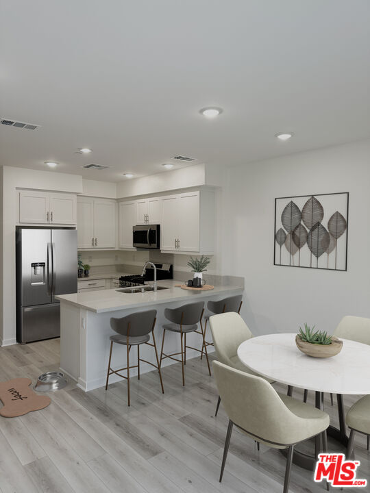 1385 Chervil Way Upland, CA 91786 - Photo 2 of 17 a living room with a couch and a dining table