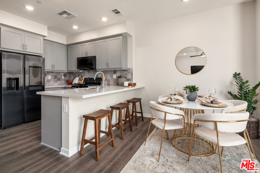 1385 Chervil Way Upland, CA 91786 - Photo 5 of 17 a kitchen with a table chairs stove and refrigerator