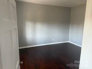 an empty room with wooden floor
