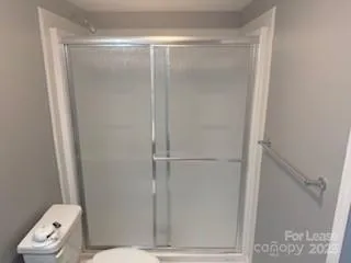 a bathroom with a glass shower door
