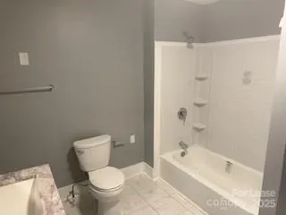 a white toilet sitting next to a bath tub