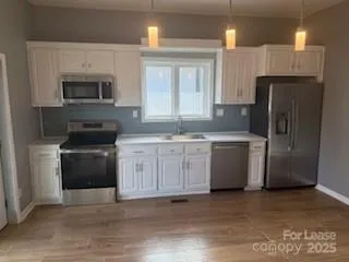a kitchen with a sink stove and refrigerator