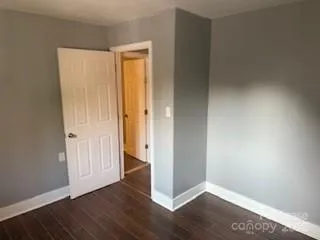 an empty room with wooden floor and closet