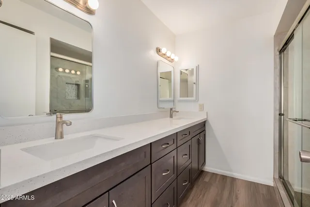 a bathroom with a double vanity sink and a mirror