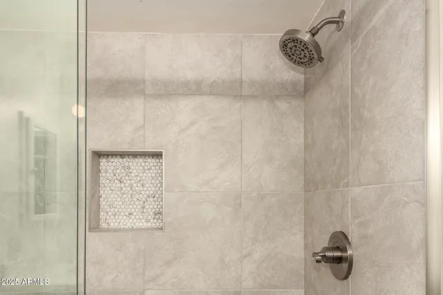 a bathroom with a glass shower door
