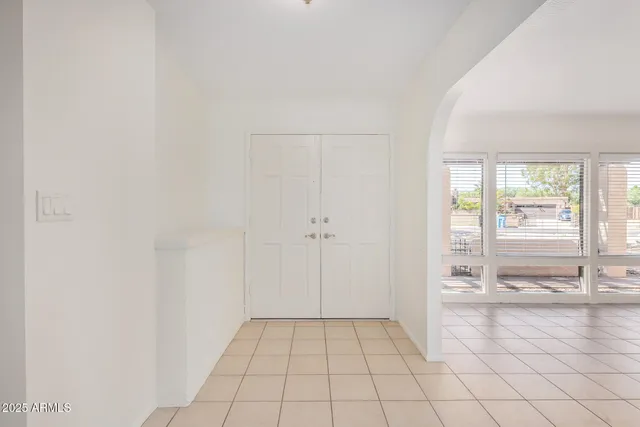 an empty room with a cabinet and mirror