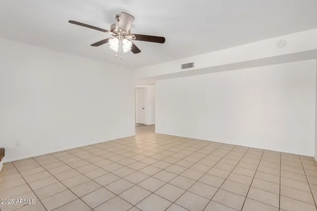 a view of a livingroom with a ceiling fan and window