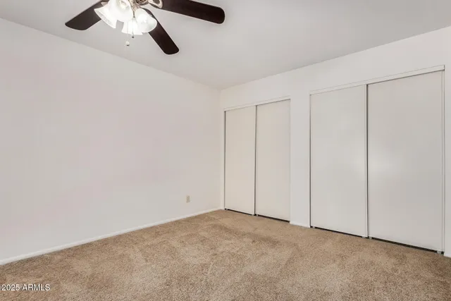 a kitchen with stainless steel appliances granite countertop a stove a sink and white cabinets