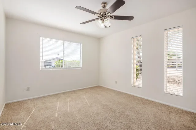 a view of a livingroom with a ceiling fan and window