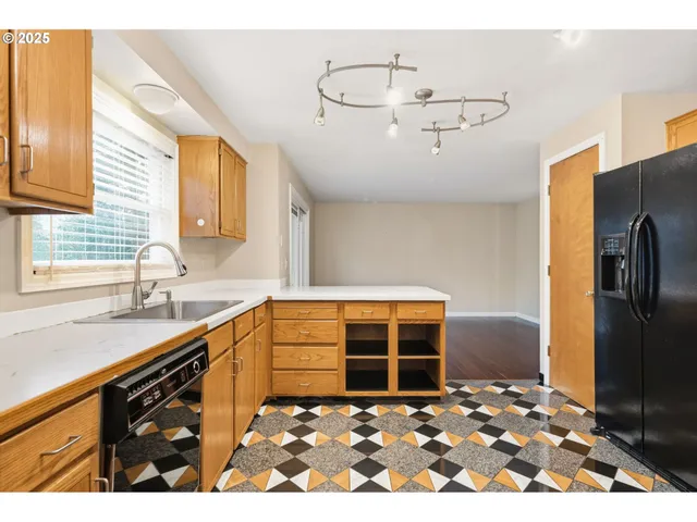 a kitchen with stainless steel appliances kitchen island granite countertop a sink stove and refrigerator