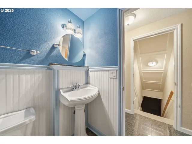 a bathroom with a sink a mirror and a toilet