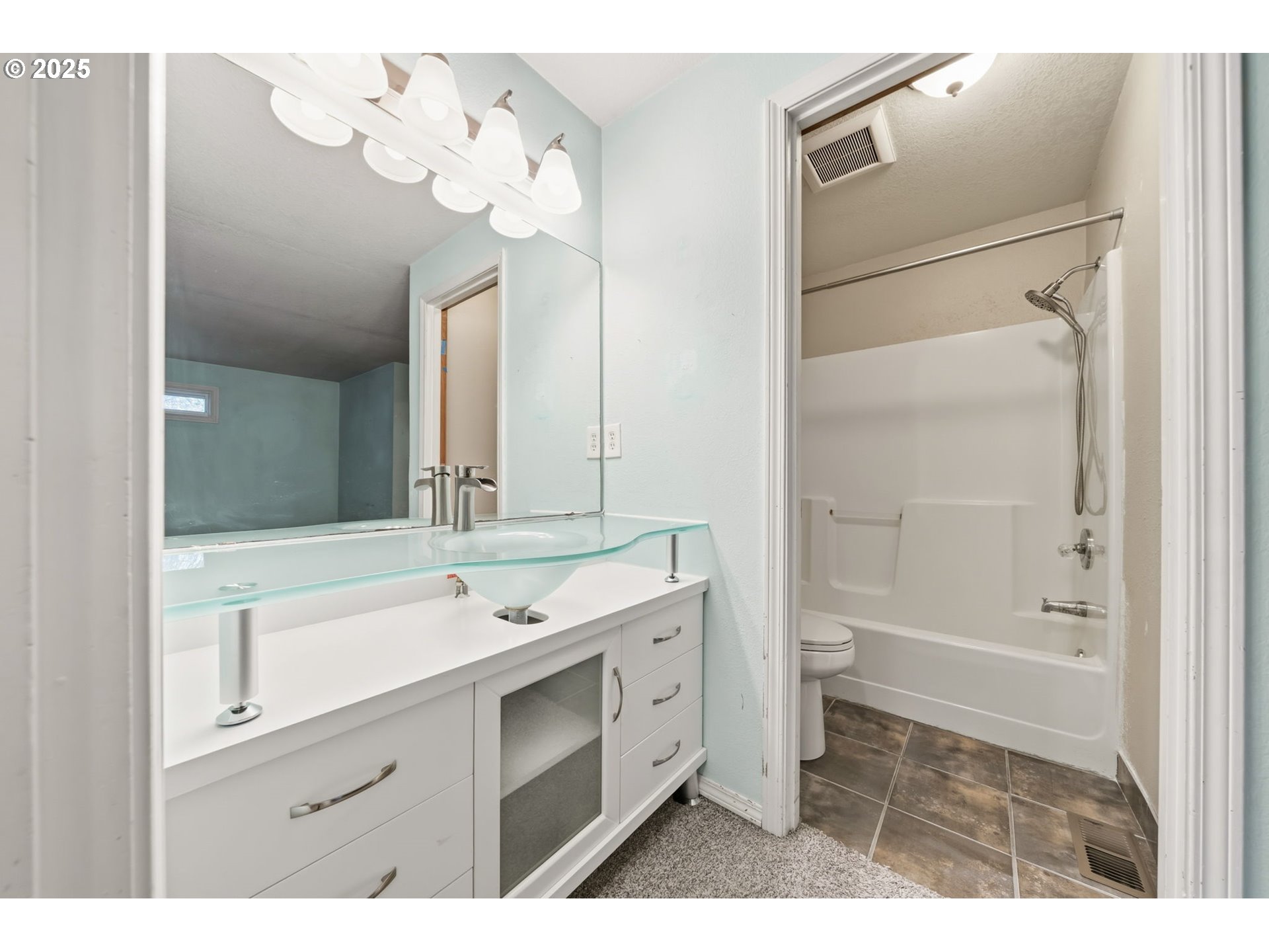 1005 Southwest 4th Street Gresham, OR 97080 - Photo 23 of 40 a bathroom with a sink a toilet and a mirror