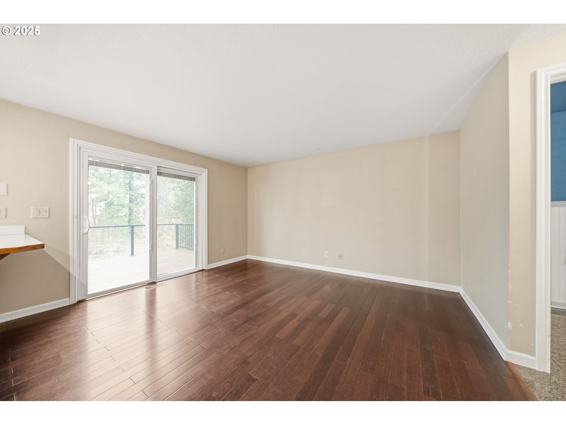 1005 Southwest 4th Street Gresham, OR 97080 - Photo 10 of 40 a view of an empty room with wooden floor and a window