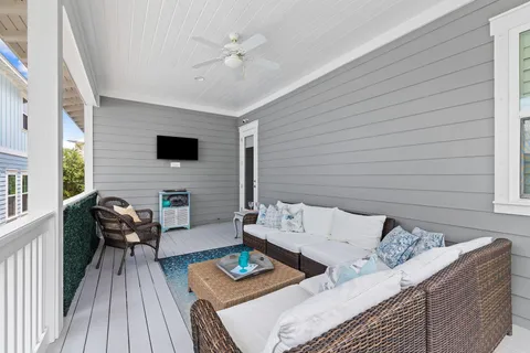 a kitchen with stainless steel appliances white cabinets a sink a stove a refrigerator and island with wooden floor