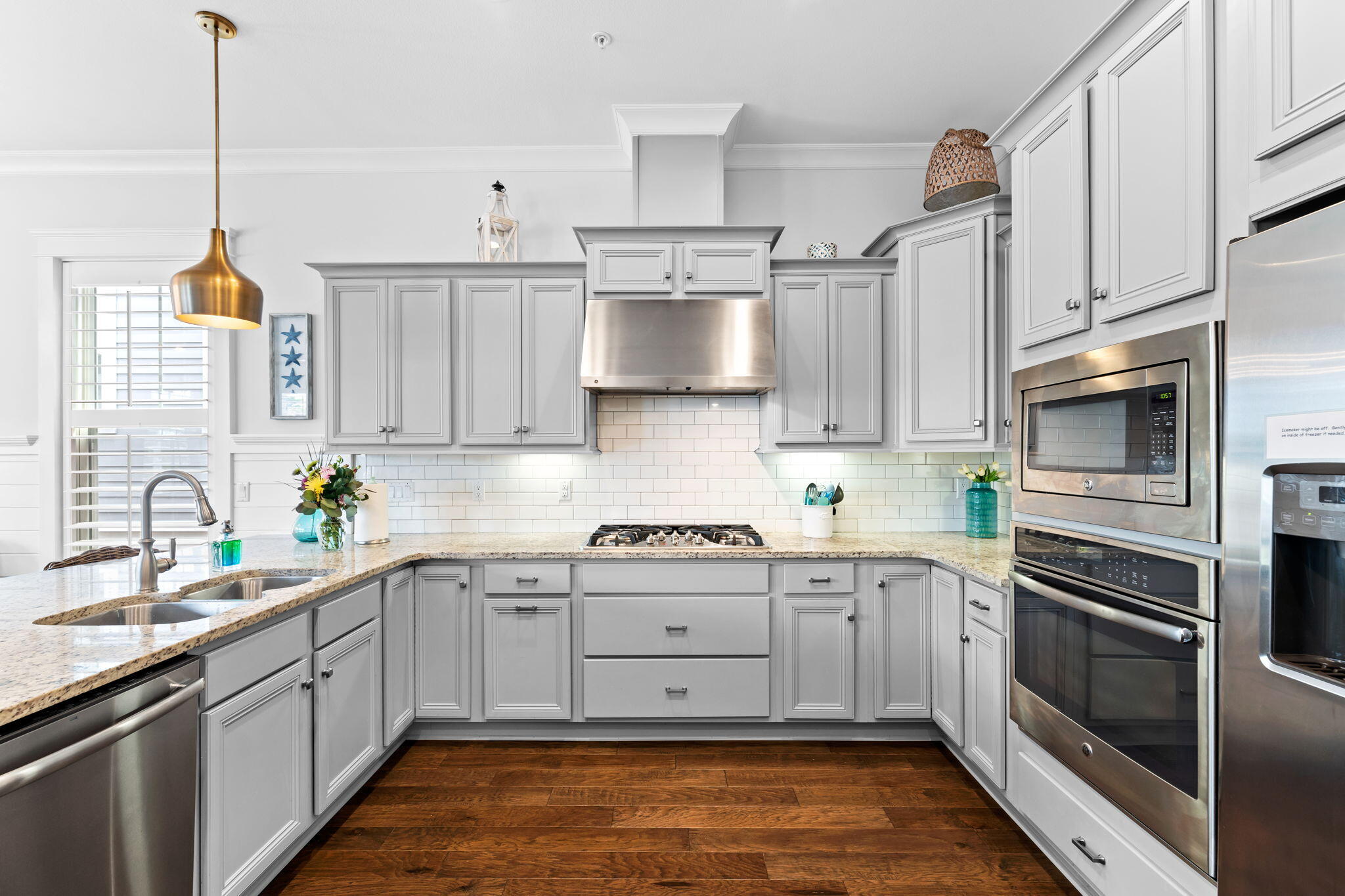 108 Gulfview Way Santa Rosa Beach, FL 32459 - Photo 20 of 51 a kitchen with stainless steel appliances white cabinets a sink a stove a refrigerator and island with wooden floor