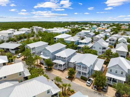 an aerial view of a house with garden space and street view