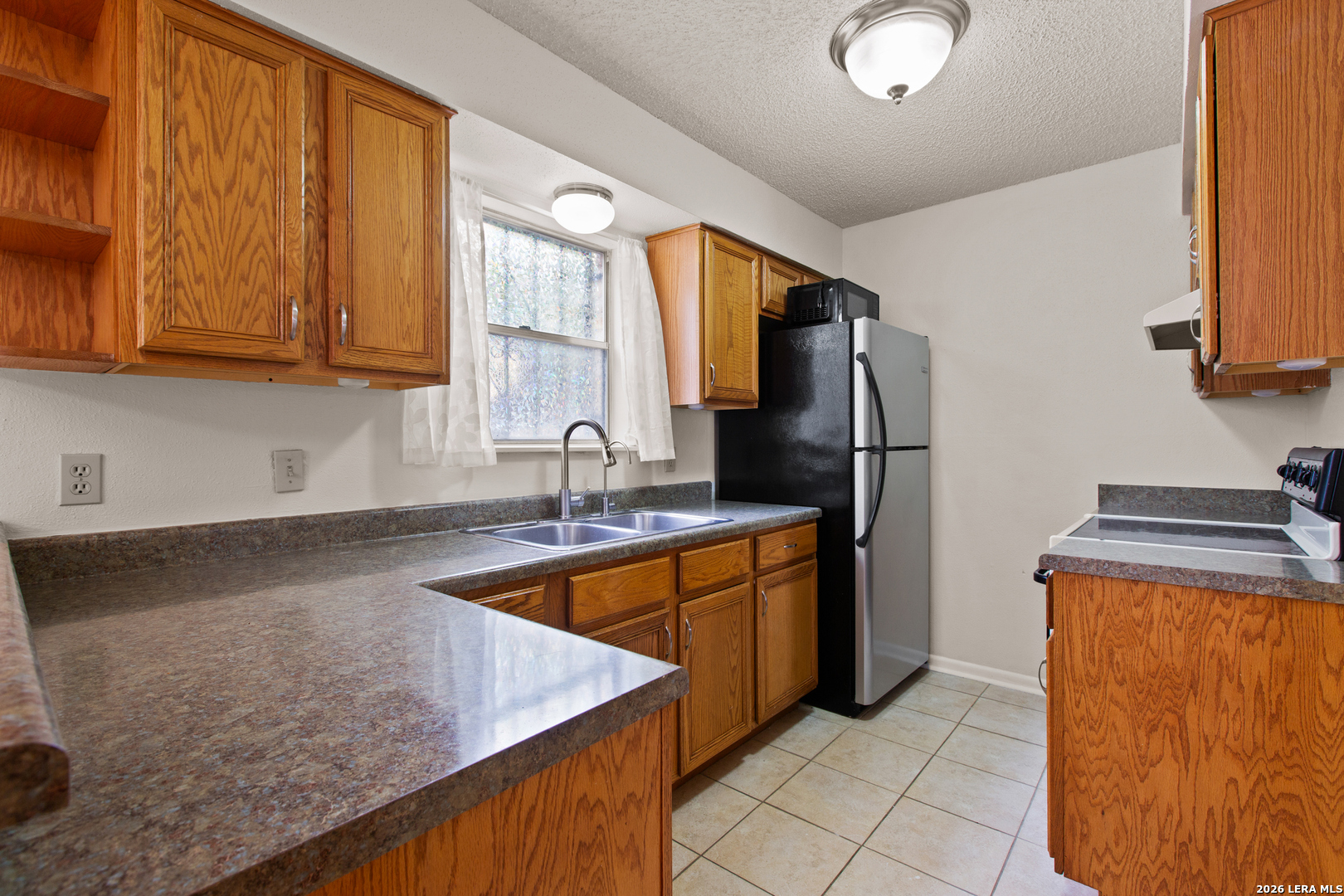 6427 Wurzbach Road, Unit 54 San Antonio, TX 78240 - Photo 3 of 18 a kitchen with stainless steel appliances granite countertop a sink stove and refrigerator