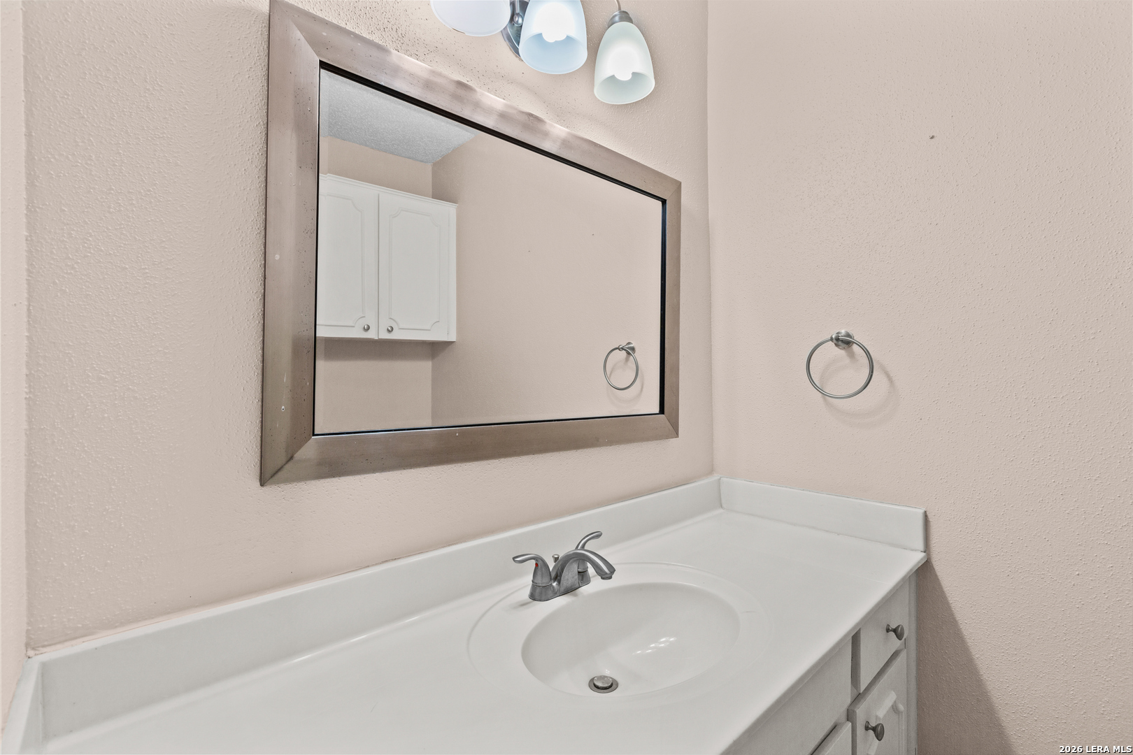 6427 Wurzbach Road, Unit 54 San Antonio, TX 78240 - Photo 5 of 18 a bathroom with a sink and a mirror