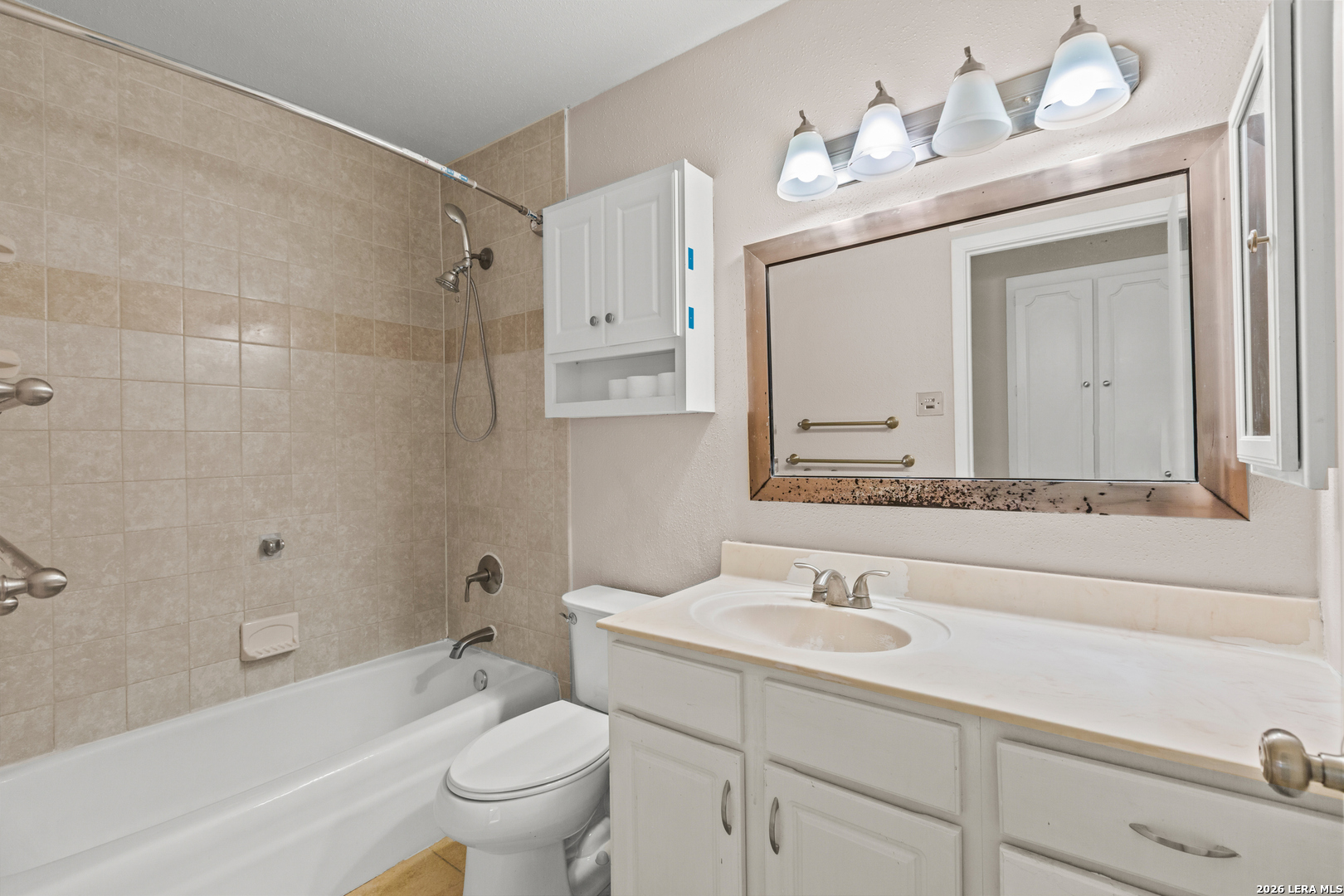 6427 Wurzbach Road, Unit 54 San Antonio, TX 78240 - Photo 8 of 18 a bathroom with a sink a toilet and a mirror