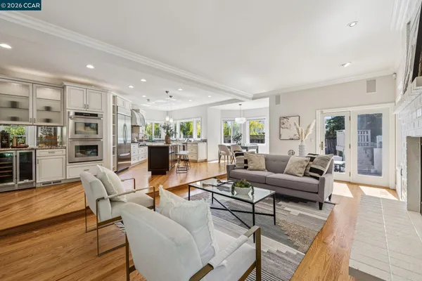 a living room with a window and a potted plant